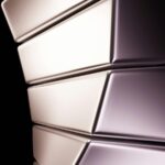 Curved metallic structure with abstract design in minimalist style.