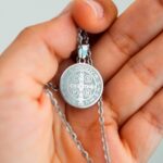 Silver pendant on hand